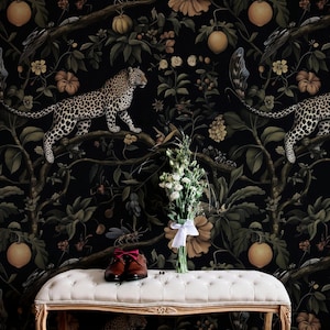 May include: Dark wallpaper with a jungle design, including leopards, flowers, and fruit. A white bench holds brown leather shoes and a bouquet of white flowers. The scene evokes a sense of luxury.