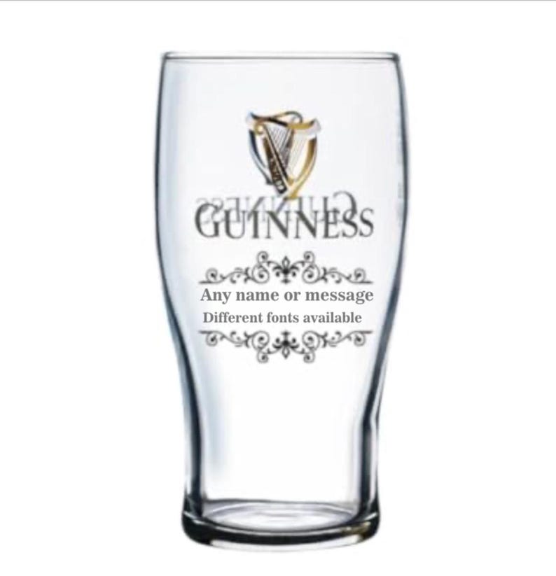 May include: A clear pint glass with the Guinness logo and text. The logo features a harp design. The text on the glass reads "GUINNESS" and "Any name or message, Different fonts available". The glass has a curved shape.
