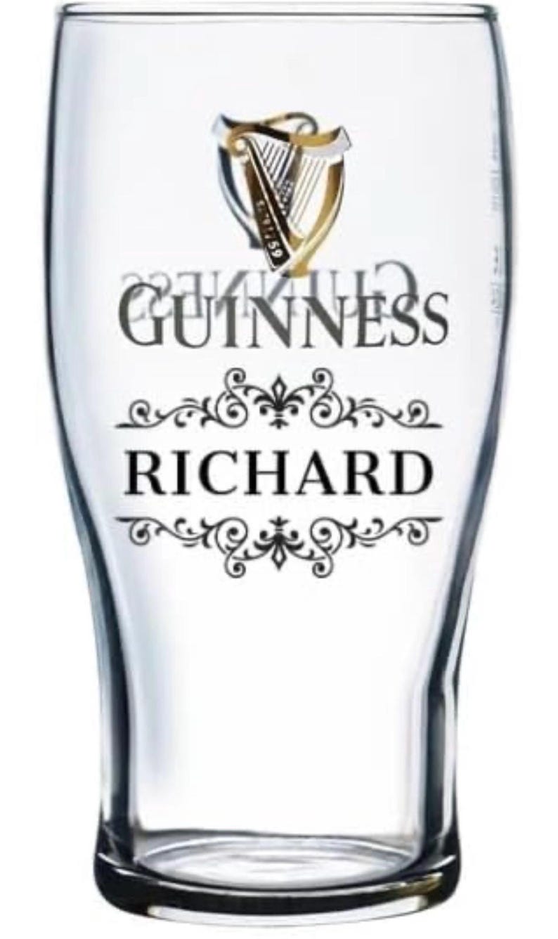 May include: A clear pint glass with the Guinness logo and the name "RICHARD" in black lettering. The Guinness logo features a harp with gold and black accents. The glass has a curved shape.