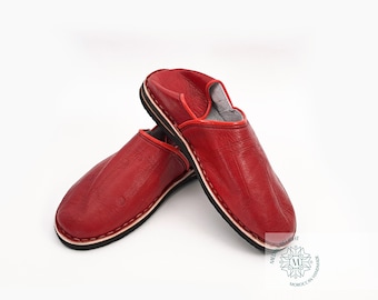 May include: A pair of red leather slippers with a black and white trim. The slippers are made of soft leather and have a comfortable fit.