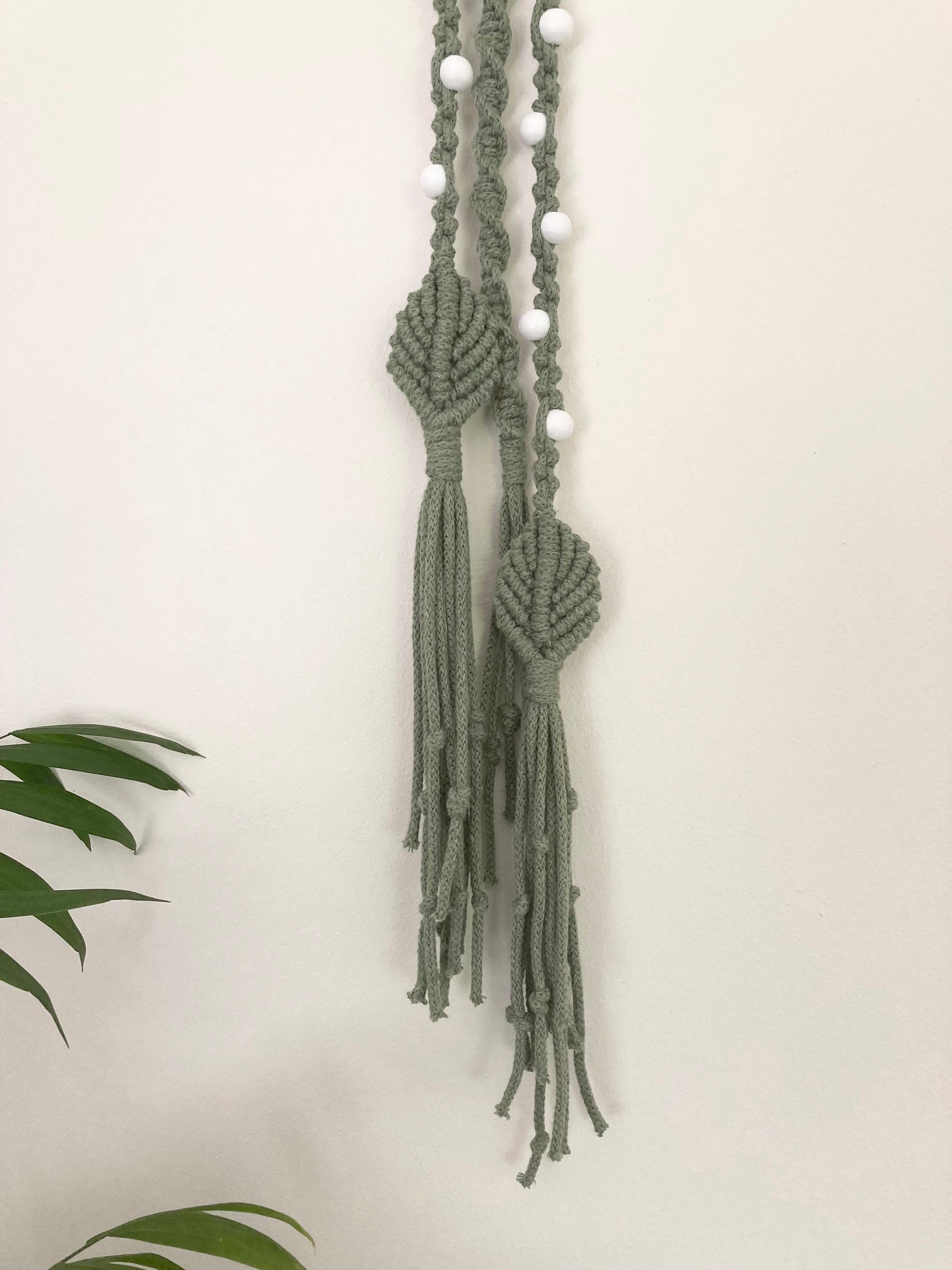 Macrame hanging decoration in green braided cord, boho, hippy, beaded decor.