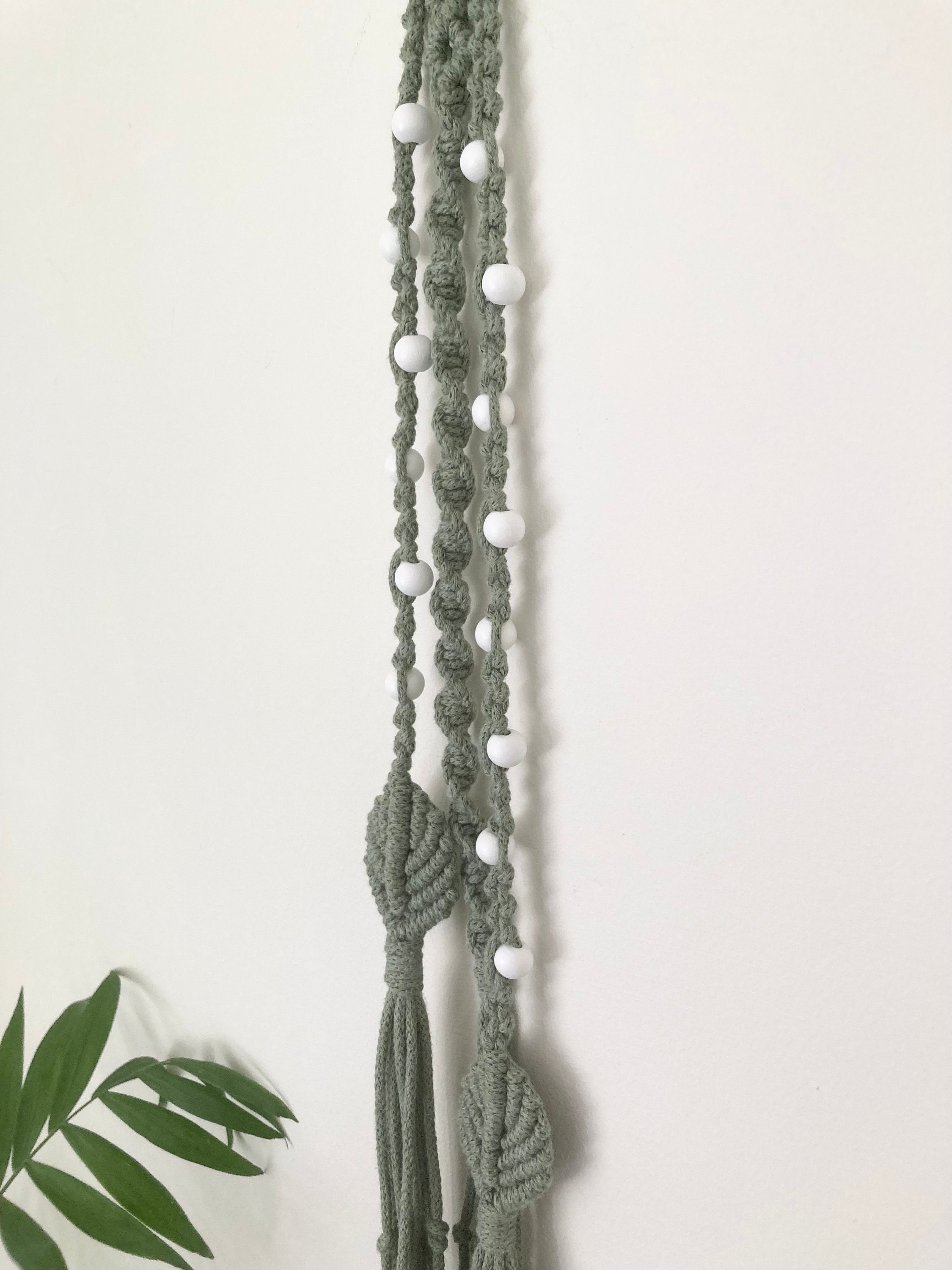 Macrame hanging decoration in green braided cord, boho, hippy, beaded decor.