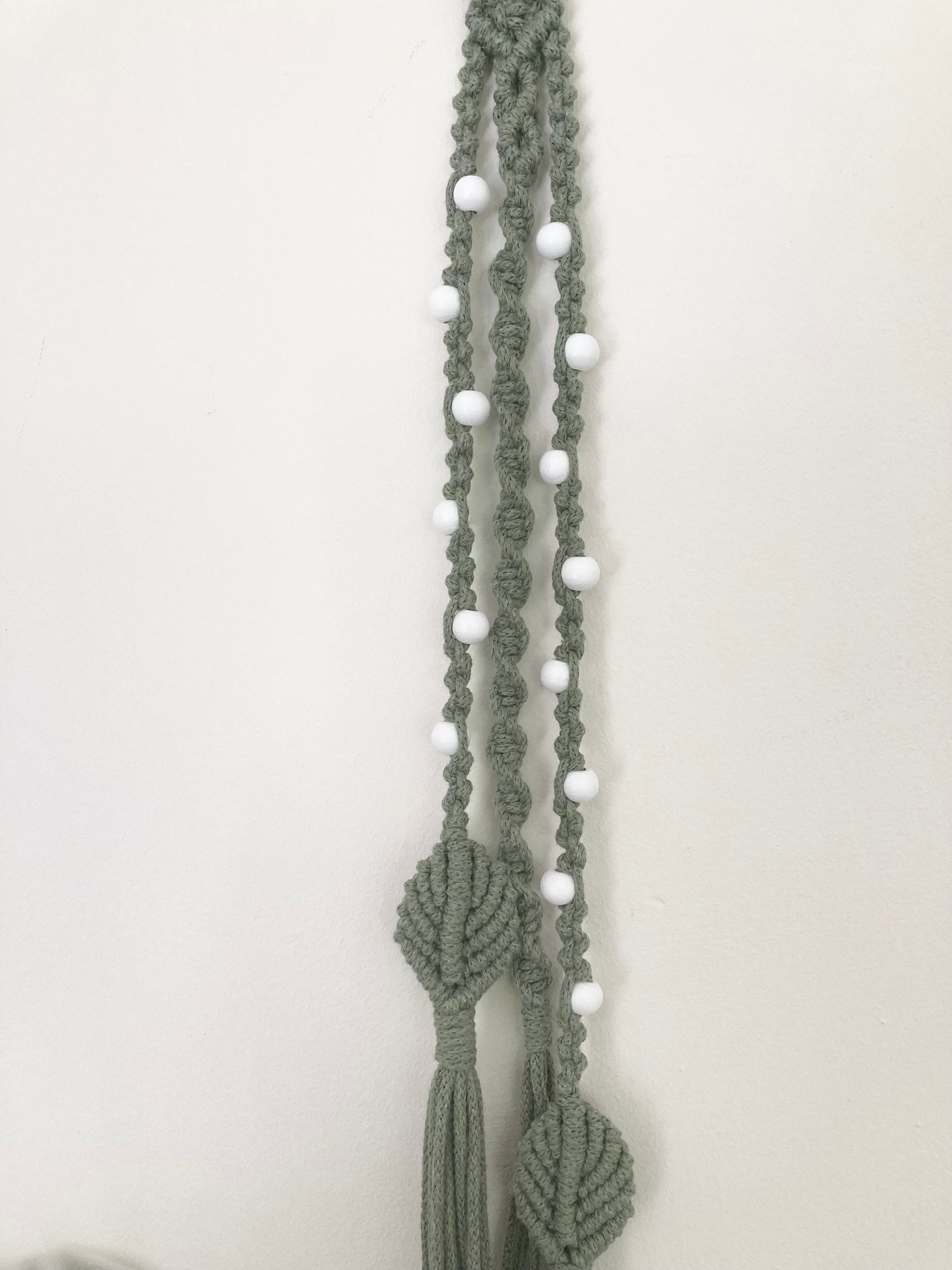 Macrame hanging decoration in green braided cord, boho, hippy, beaded decor.