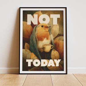May include: Framed art print featuring a bird wrapped in a blanket, holding a cup of coffee. The words "NOT TODAY" are printed in large white letters. The background includes autumn leaves in shades of yellow and brown.
