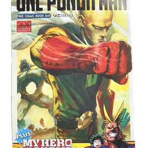 May include: A comic book cover featuring the title "ONE-PUNCH MAN" in large, bold letters. The cover art depicts a muscular figure in a yellow and green suit with a red fist. The bottom of the cover includes "MY HERO ACADEMIA" and the author's name.