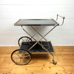 Vintage midden van de eeuw moderne zwarte en gouden barwagen | Stalen theewagen met glazen planken | Elegante serveerwagen