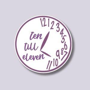 May include: A white circle with a purple clock face that reads "ten till eleven" with the hands pointing to 10:50. The numbers 1 through 12 are around the clock face.