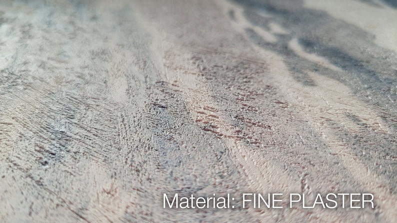May include: A close-up view of a textured surface made of fine plaster, featuring a mottled pattern of light beige, grey, and dark charcoal streaks. The surface has a rough, uneven finish with visible grain-like markings. Text reads: Material: FINE PLASTER.