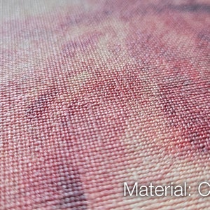 May include: A close-up view of a woven canvas fabric featuring a textured surface with a printed pattern in shades of deep red, purple, and cream. The text "Material: CANVAS" is clearly visible in the bottom right corner of the image.