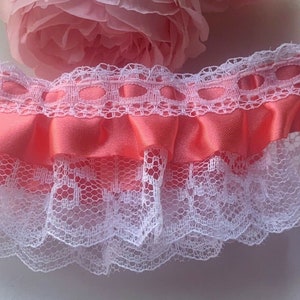 1 1/2  or 2 inch wide white/coral color  ruffled lace price per yard