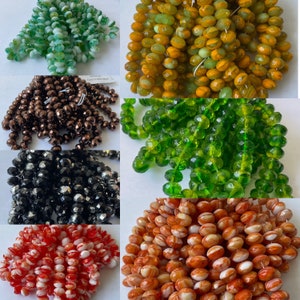 May include: Assortment of glass beads in various colors and shapes, including green, orange, brown, black, and red. The beads are perfect for jewelry making, crafting, and home decor.