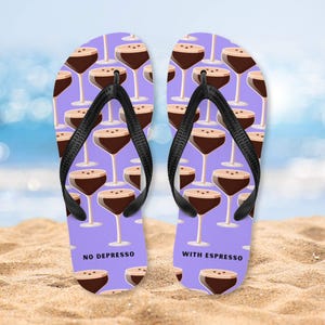 May include: A pair of purple flip flops with a pattern of espresso martinis. One flip flop says "No Depresso" and the other says "With Espresso".
