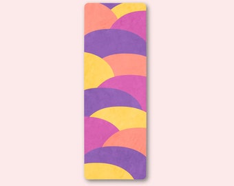 May include: A colorful bookmark with a pattern of overlapping yellow, pink, and purple semi-circles.