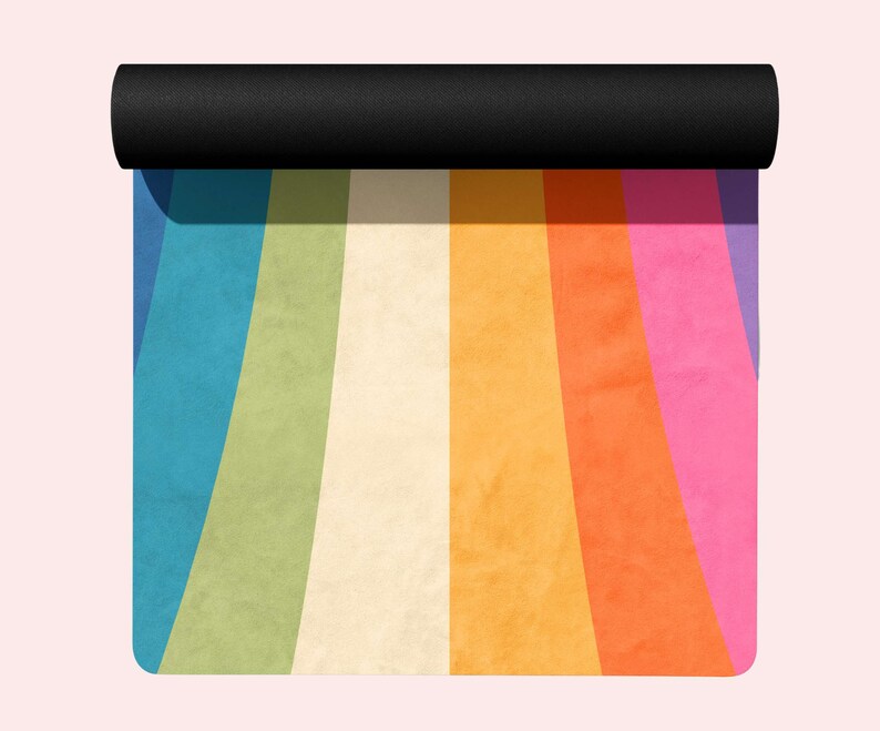 May include: A rolled up yoga mat with a rainbow design. The mat has stripes of blue, green, cream, yellow, orange, pink, and purple.