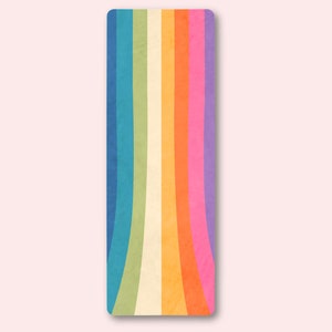 May include: A colorful yoga mat with a rainbow design. The mat has a textured surface and is perfect for yoga, pilates, or stretching.