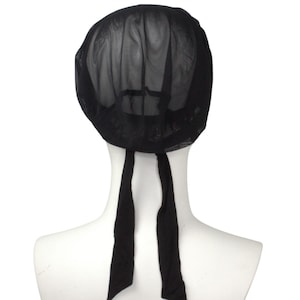 May include: Black mesh hair net with two long ties. The net is made of a fine mesh material and is designed to keep hair out of the way.