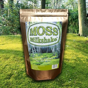 May include: A brown pouch of "MOSS Milkshake" moss garden mix. The label features a green and white logo with the product name and a forest scene. The text "Grow a Moss Garden... Just Add Water" is also visible.