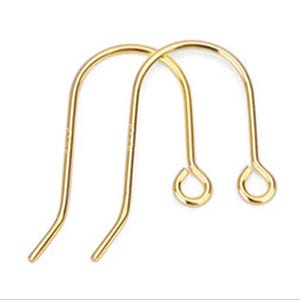 May include: Two gold-colored earring hooks. The hooks have a curved top and a loop at the bottom for attaching earrings. The hooks are made of a shiny, metallic material.