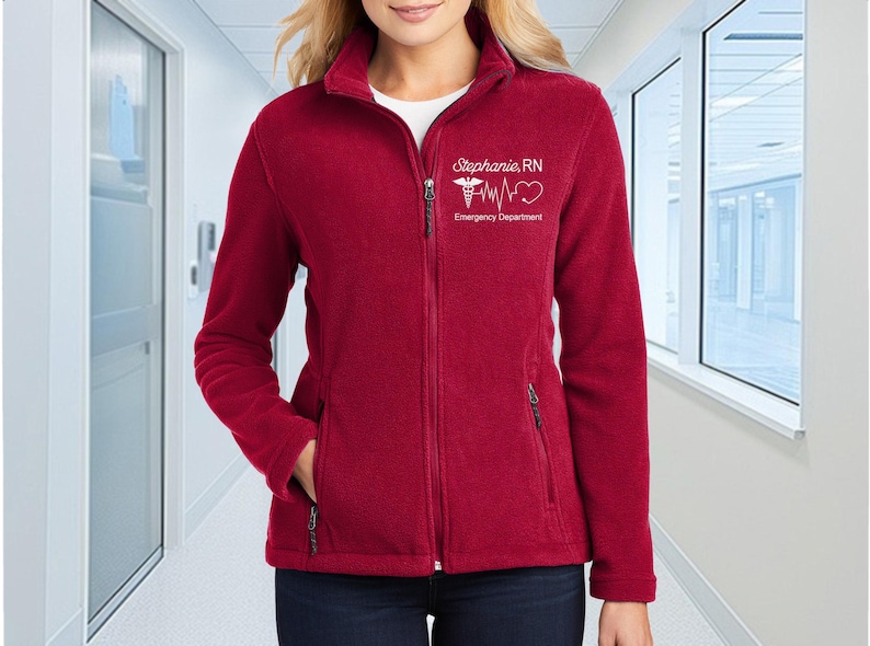 a woman in a red jacket standing in a hallway