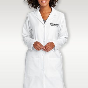 May include: A white lab coat with a long sleeve and two pockets. The coat has a name tag that reads "Jennifer K. Anderson, Emergency Medicine."
