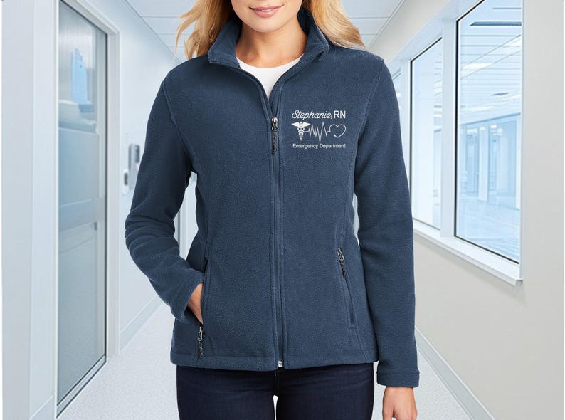 a woman in a blue jacket standing in a hallway