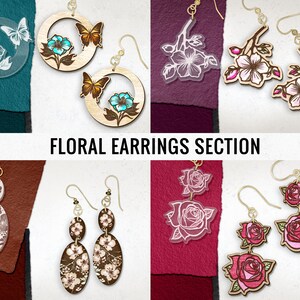 May include: A collection of floral earrings with various designs. Some earrings feature butterflies and flowers, while others showcase roses and cherry blossoms. The earrings are made of wood and acrylic, with gold-colored hooks. The text "FLORAL EARRINGS SECTION" is displayed.