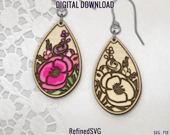 May include: Wooden teardrop earrings with floral designs. One earring features a vibrant pink flower with green and purple accents, while the other has a similar design in a darker outline. The earrings are suspended from silver-colored hooks. The text "DIGITAL DOWNLOAD" and "RefinedSVG" are visible.