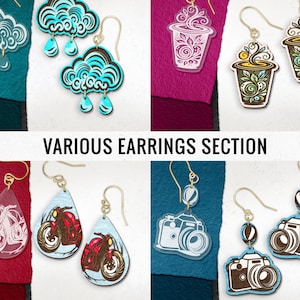 May include: Assortment of various earrings featuring different designs.  The earrings include a cloud design with raindrops, a coffee cup design, a motorcycle design, and a camera design.  The earrings are made of wood and acrylic.