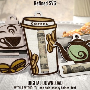 May include: Three wooden cutouts of a coffee cup, a teapot, and a coffee mug. Each cutout has a slot for a rolled up dollar bill. The coffee cup cutout has the word "COFFEE" written on it. The teapot cutout has a green interior. The coffee mug cutout has a brown interior. The cutouts are on a light brown wooden surface.