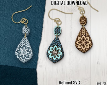 May include: Three pairs of snowflake-themed earrings with gold-colored hooks. The earrings feature a teardrop shape with a snowflake design. One pair is white, one is turquoise, and one is light brown. The text "DIGITAL DOWNLOAD" and "Refined SVG" are visible.