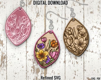 May include: Two pairs of earrings with a floral design. One pair is pink with white flowers and the other pair is wood with brown flowers.