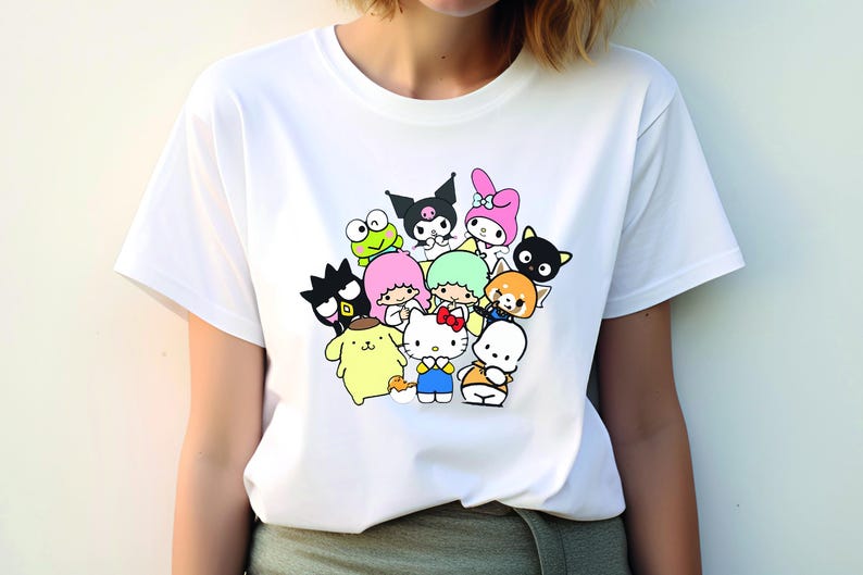 May include: White t-shirt with a colorful graphic print of various cartoon characters, including Hello Kitty, My Melody, and Keroppi.
