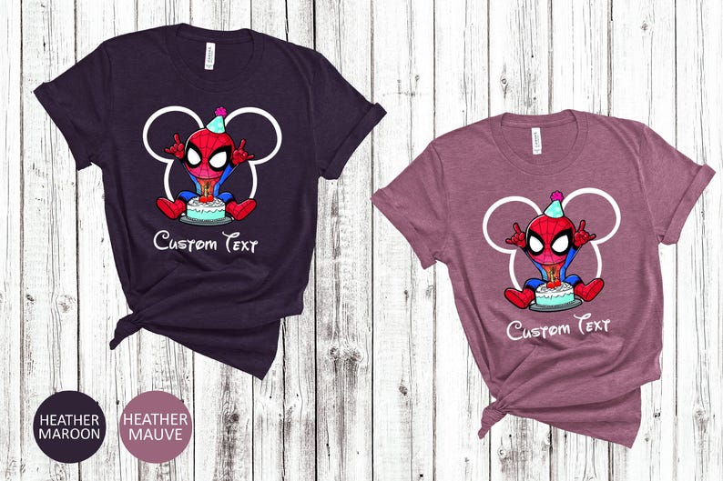 May include: Two t-shirts, one heather maroon and one heather mauve, featuring a cartoon Spider-Man character with a birthday cake. The design includes a white outline of Mickey Mouse ears and the text "Custom Text".