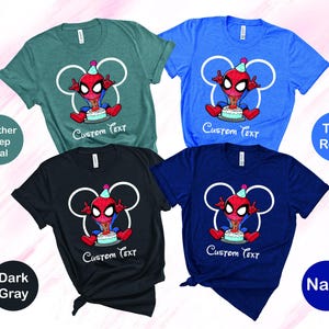 May include: Four short-sleeved t-shirts in teal, blue, black, and navy. Each shirt features a cartoon Spider-Man character with a birthday cake and the text "Custom Text". The shirts are labeled "Heather Deep Teal", "True Royal", "Dark Gray", and "Navy".