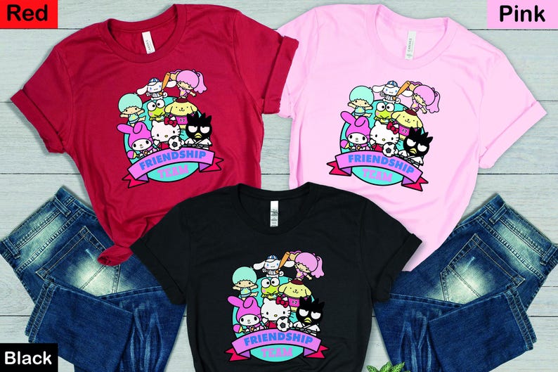 May include: Three t-shirts in red, pink, and black with a graphic of cartoon characters and the text "Friendship Team".