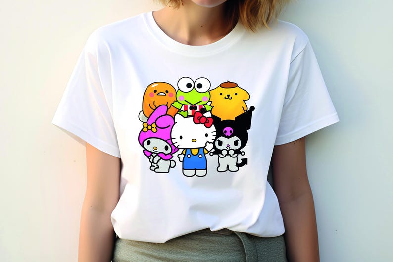 May include: White t-shirt featuring a graphic print of popular cartoon characters, including Hello Kitty, Keroppi, My Melody, and Tuxedo Sam.