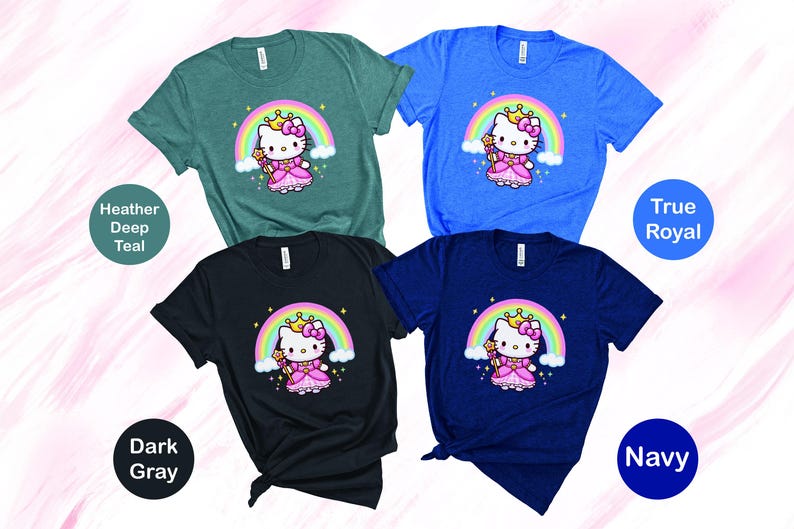 May include: Four short-sleeved t-shirts in teal, blue, dark gray, and navy. Each shirt features a cartoon character with a crown and wand in front of a rainbow. The shirts are labeled with their color names.