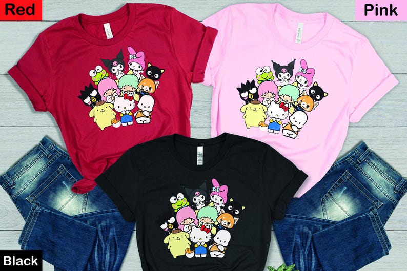 May include: Three t-shirts with a graphic print of various cartoon characters, including Hello Kitty, My Melody, and Keroppi. The t-shirts are available in red, pink, and black.