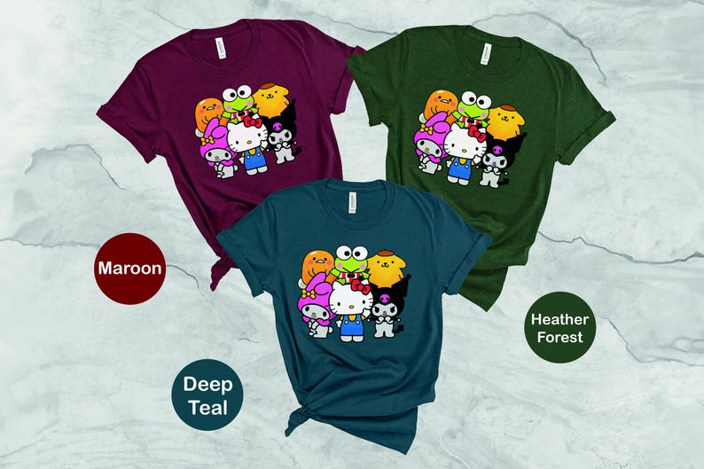 May include: Three t-shirts featuring a group of cartoon characters including Hello Kitty and a frog. The t-shirts are in maroon, deep teal and heather forest.