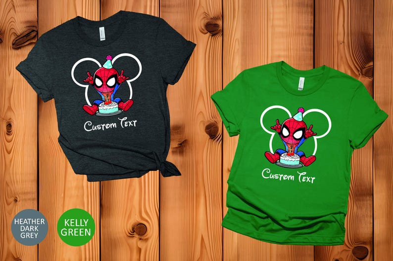 May include: Two t-shirts, one heather dark grey and one kelly green, with a cartoon Spider-Man design and a birthday cake. The design includes white Mickey Mouse ears and the words "Custom Text".