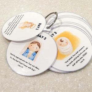 May include: A set of 10 round, white cards with colorful illustrations and text. Each card has a number from 1 to 10, and a Bible verse about the birth of Jesus. The cards are connected by a silver ring.