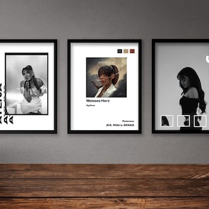 May include: Three framed black and white photographs of a woman. The first photo shows a woman singing with the word "ayliva" repeated in a diagonal pattern. The second photo shows a woman with a white jacket and the text "Weisses Herz" and "Release 24. März 2023". The third photo shows a woman in a black dress with the word "ayliva" written vertically.