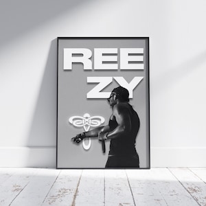May include: A black and white poster with the text "REEZY" in white letters. A person is shown in the poster, standing in profile, wearing a black tank top and holding a microphone.