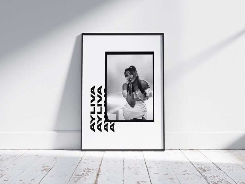 May include: Black and white photo print of a woman singing on stage. The photo is framed in a black frame and the woman's name "AYLIVA" is repeated in a bold, black font on the white background.