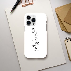 May include: White iPhone case with a black outline of a heart and the name "Ayliva" written in cursive.