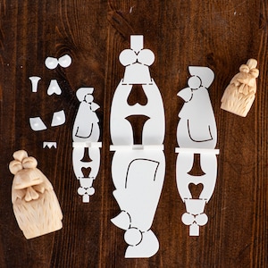 May include: A white paper craft kit for making a rooster. The kit includes a rooster body, a rooster head, and a rooster tail. The kit also includes a bow tie and other decorative elements.