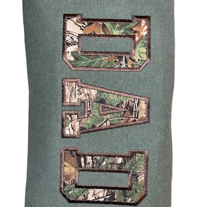May include: Green sweatshirt with the word "DAD" embroidered in brown with a camouflage pattern.