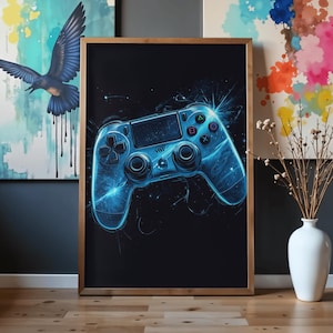 May include: A framed rectangular wall art print featuring a glowing blue digital illustration of a video game controller against a solid black background. The controller design includes standard directional buttons, dual analog sticks, and action symbols.