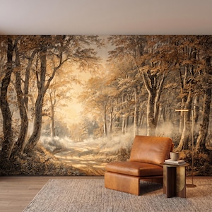 May include: A wall mural depicting a forest landscape with tall trees in shades of brown and gold, featuring a dirt path leading into a misty, sunlit background. A tan leather armchair sits in front of the mural next to a small side table.