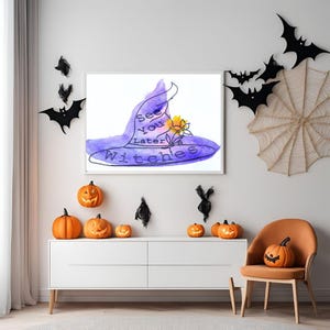 May include: A framed watercolor painting of a purple witch's hat with a yellow flower on top. The text "See you later witches" is written on the hat.